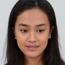 Joyful asian young-adult female with long  brown hair and brown eyes