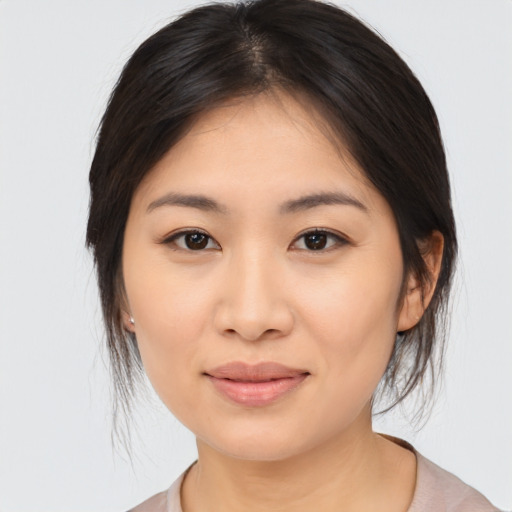 Joyful asian young-adult female with medium  brown hair and brown eyes
