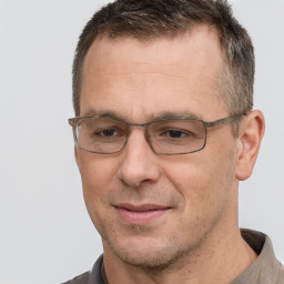 Joyful white adult male with short  brown hair and brown eyes