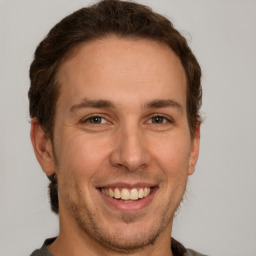 Joyful white adult male with short  brown hair and grey eyes