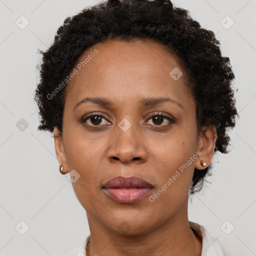 Joyful black adult female with short  brown hair and brown eyes