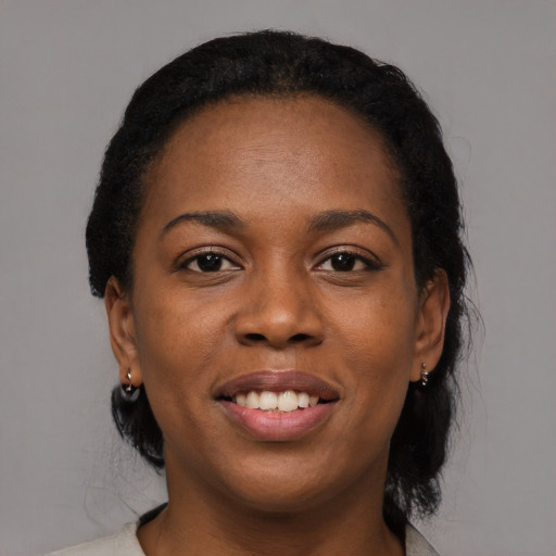 Joyful black young-adult female with medium  black hair and brown eyes