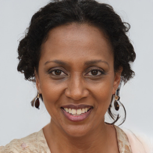 Joyful black adult female with short  brown hair and brown eyes