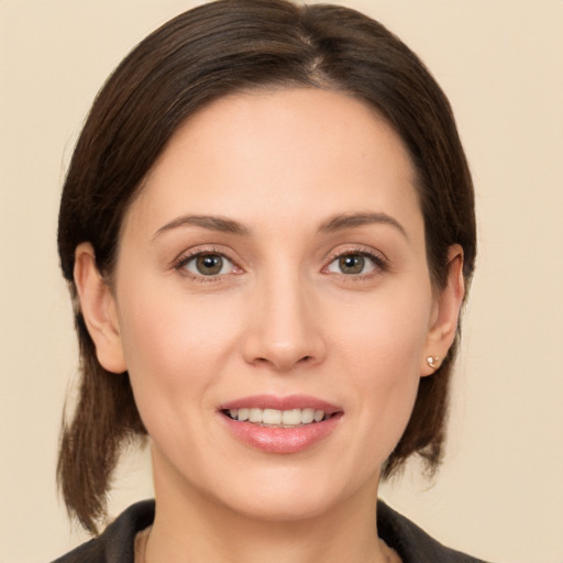 Joyful white young-adult female with medium  brown hair and brown eyes