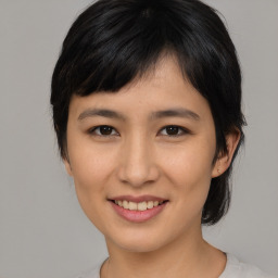 Joyful asian young-adult female with medium  black hair and brown eyes