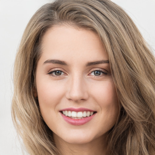 Joyful white young-adult female with long  brown hair and green eyes