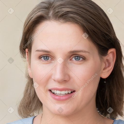 Joyful white young-adult female with medium  brown hair and blue eyes