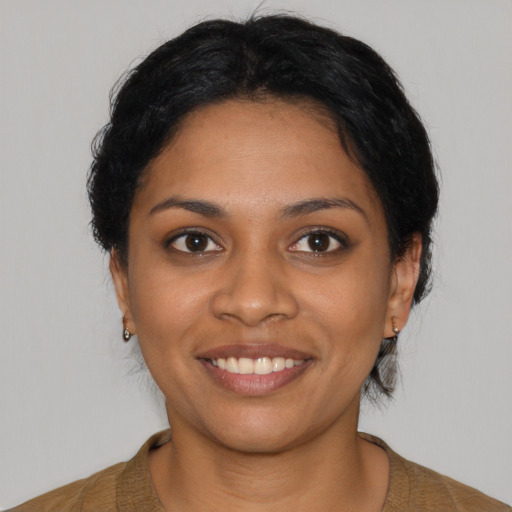 Joyful latino young-adult female with short  black hair and brown eyes