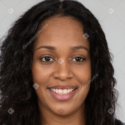 Joyful black young-adult female with long  brown hair and brown eyes