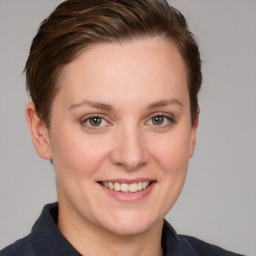 Joyful white young-adult female with short  brown hair and grey eyes