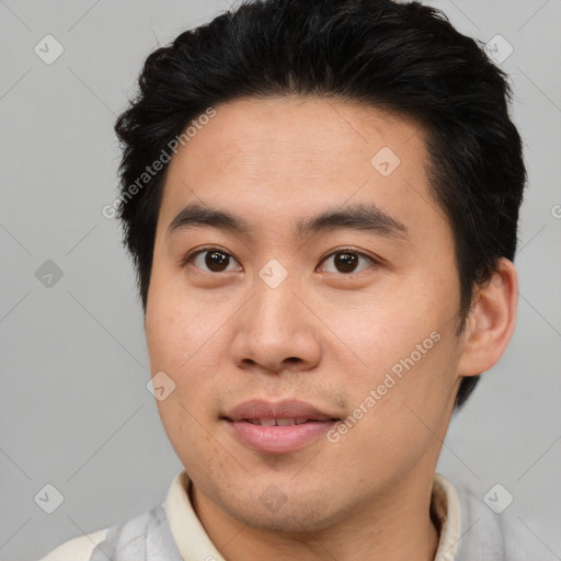 Joyful asian young-adult male with short  brown hair and brown eyes