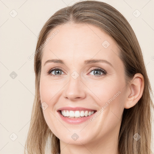 Joyful white young-adult female with long  brown hair and grey eyes