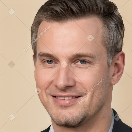 Joyful white adult male with short  brown hair and brown eyes