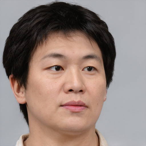 Neutral asian adult male with short  brown hair and brown eyes