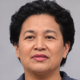 Joyful latino adult female with short  brown hair and brown eyes