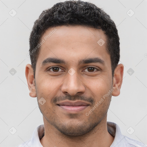 Joyful black young-adult male with short  black hair and brown eyes