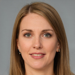 Joyful white adult female with long  brown hair and brown eyes