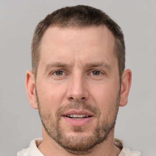 Joyful white adult male with short  brown hair and brown eyes