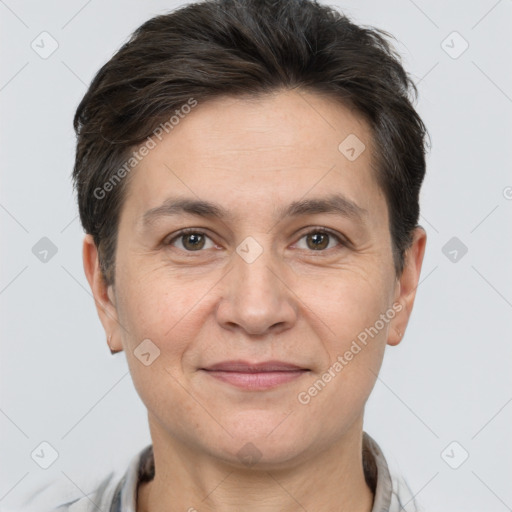 Joyful white adult female with short  brown hair and brown eyes