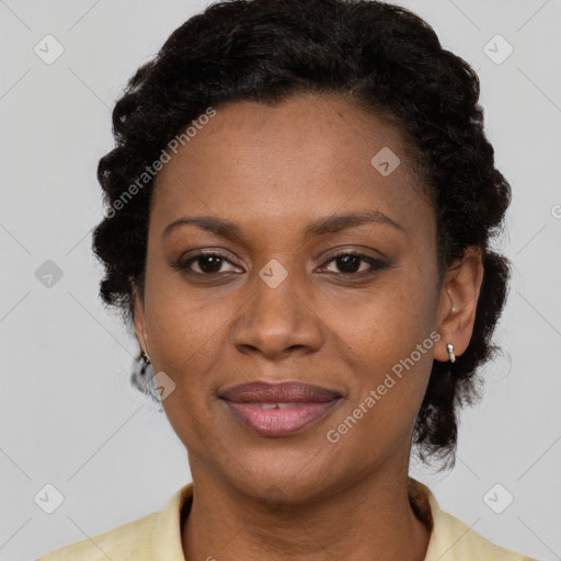 Joyful black adult female with short  brown hair and brown eyes