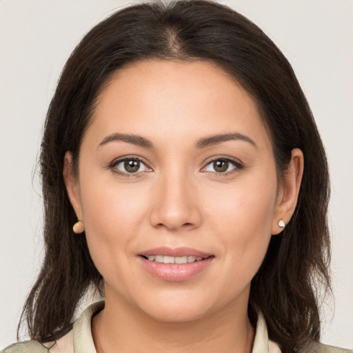 Joyful white young-adult female with medium  brown hair and brown eyes