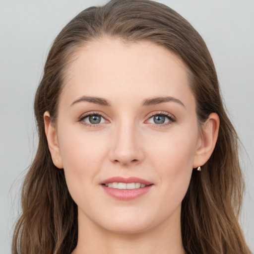 Joyful white young-adult female with long  brown hair and grey eyes