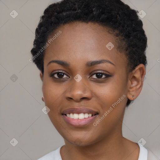 Joyful black young-adult female with short  black hair and brown eyes