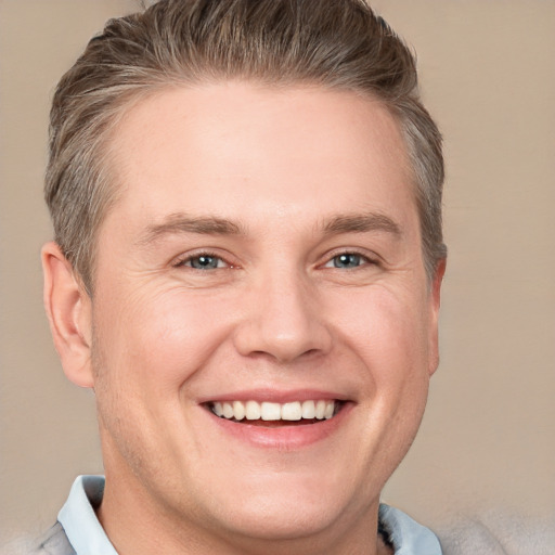 Joyful white adult male with short  brown hair and grey eyes