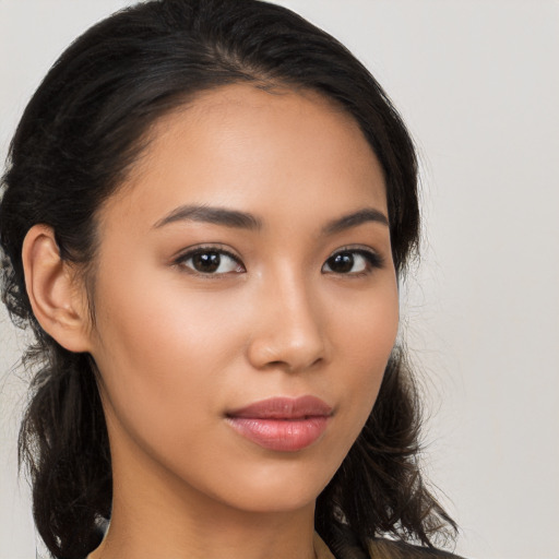 Joyful latino young-adult female with medium  brown hair and brown eyes