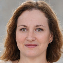 Joyful white adult female with medium  brown hair and brown eyes