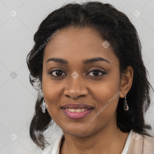 Joyful black young-adult female with long  black hair and brown eyes