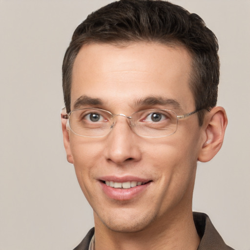 Joyful white adult male with short  brown hair and grey eyes