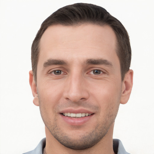 Joyful white young-adult male with short  brown hair and brown eyes