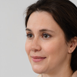 Joyful white adult female with long  brown hair and brown eyes