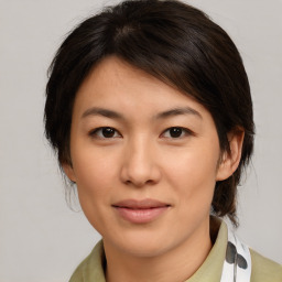 Joyful asian young-adult female with medium  brown hair and brown eyes