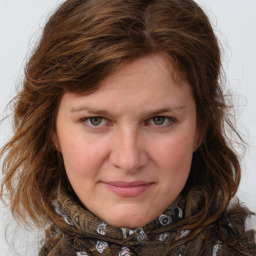 Joyful white young-adult female with medium  brown hair and blue eyes