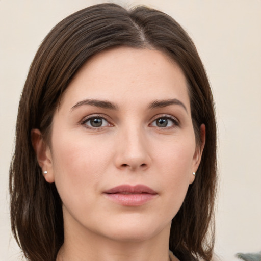 Joyful white young-adult female with medium  brown hair and grey eyes