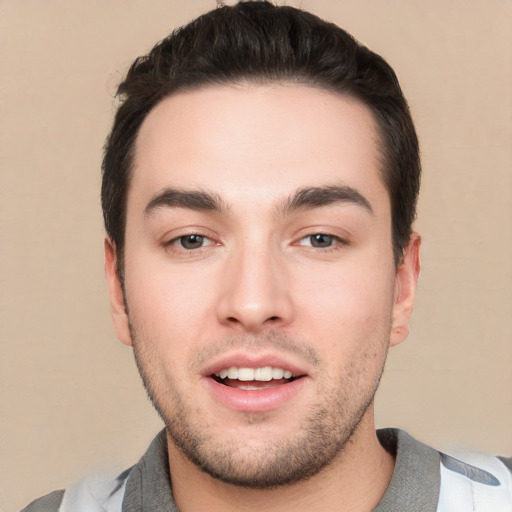 Joyful white young-adult male with short  black hair and brown eyes