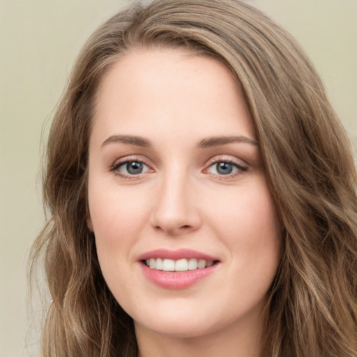 Joyful white young-adult female with long  brown hair and green eyes