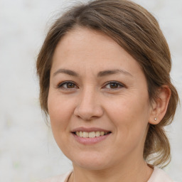 Joyful white young-adult female with medium  brown hair and brown eyes