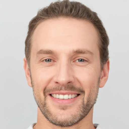 Joyful white young-adult male with short  brown hair and brown eyes