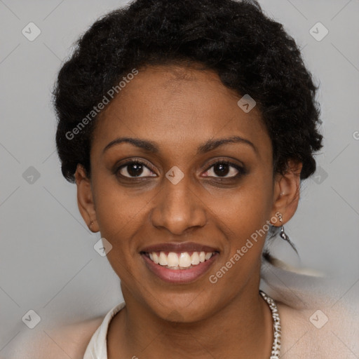 Joyful black young-adult female with short  black hair and brown eyes