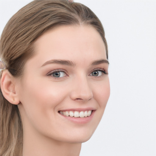 Joyful white young-adult female with long  brown hair and grey eyes