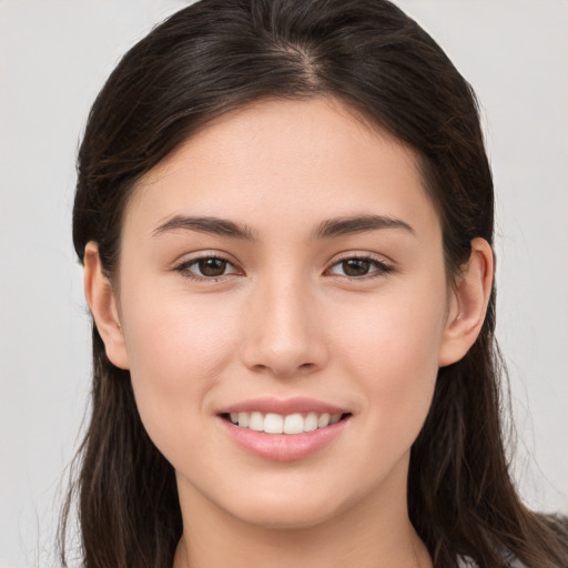 Joyful white young-adult female with long  brown hair and brown eyes