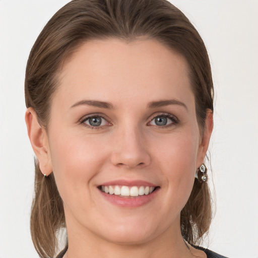 Joyful white young-adult female with long  brown hair and grey eyes