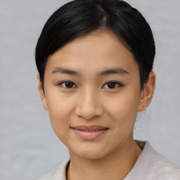 Joyful asian young-adult female with short  brown hair and brown eyes