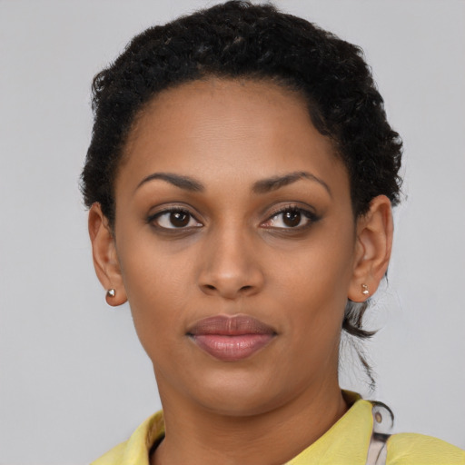 Joyful latino young-adult female with short  black hair and brown eyes