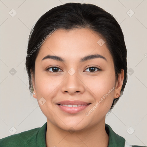 Joyful latino young-adult female with medium  brown hair and brown eyes