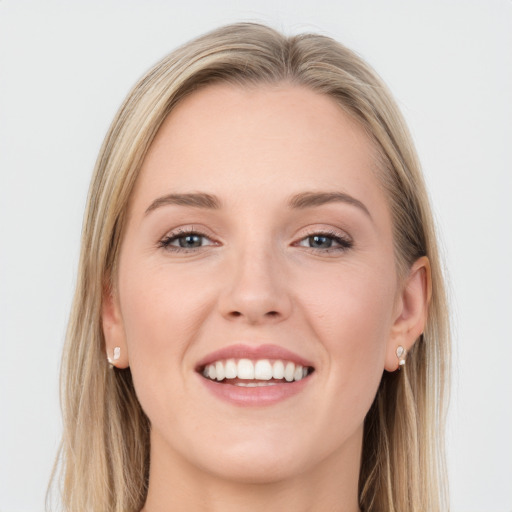 Joyful white young-adult female with long  brown hair and blue eyes