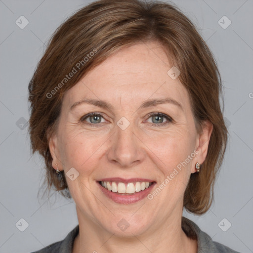 Joyful white adult female with medium  brown hair and grey eyes